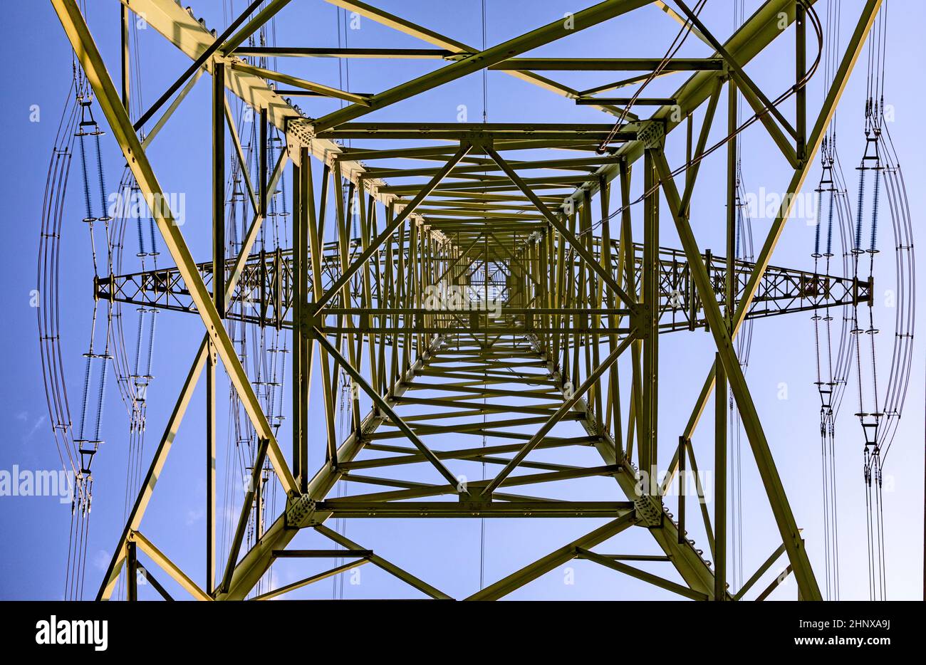 electric pylon under blue sky as industry background Stock Photo - Alamy