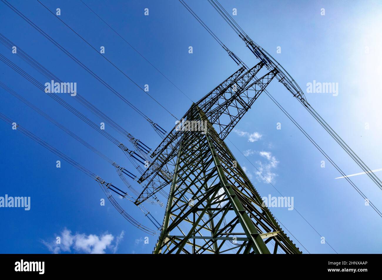electric pylon under blue sky as industry background Stock Photo - Alamy