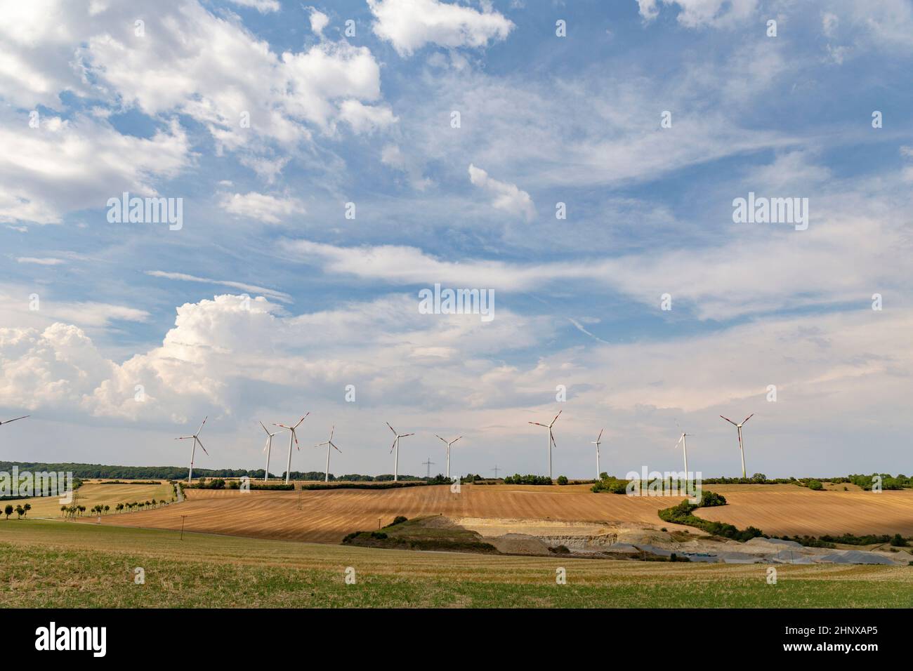 electricity wind turbin at the field under cloudy sky Stock Photo - Alamy