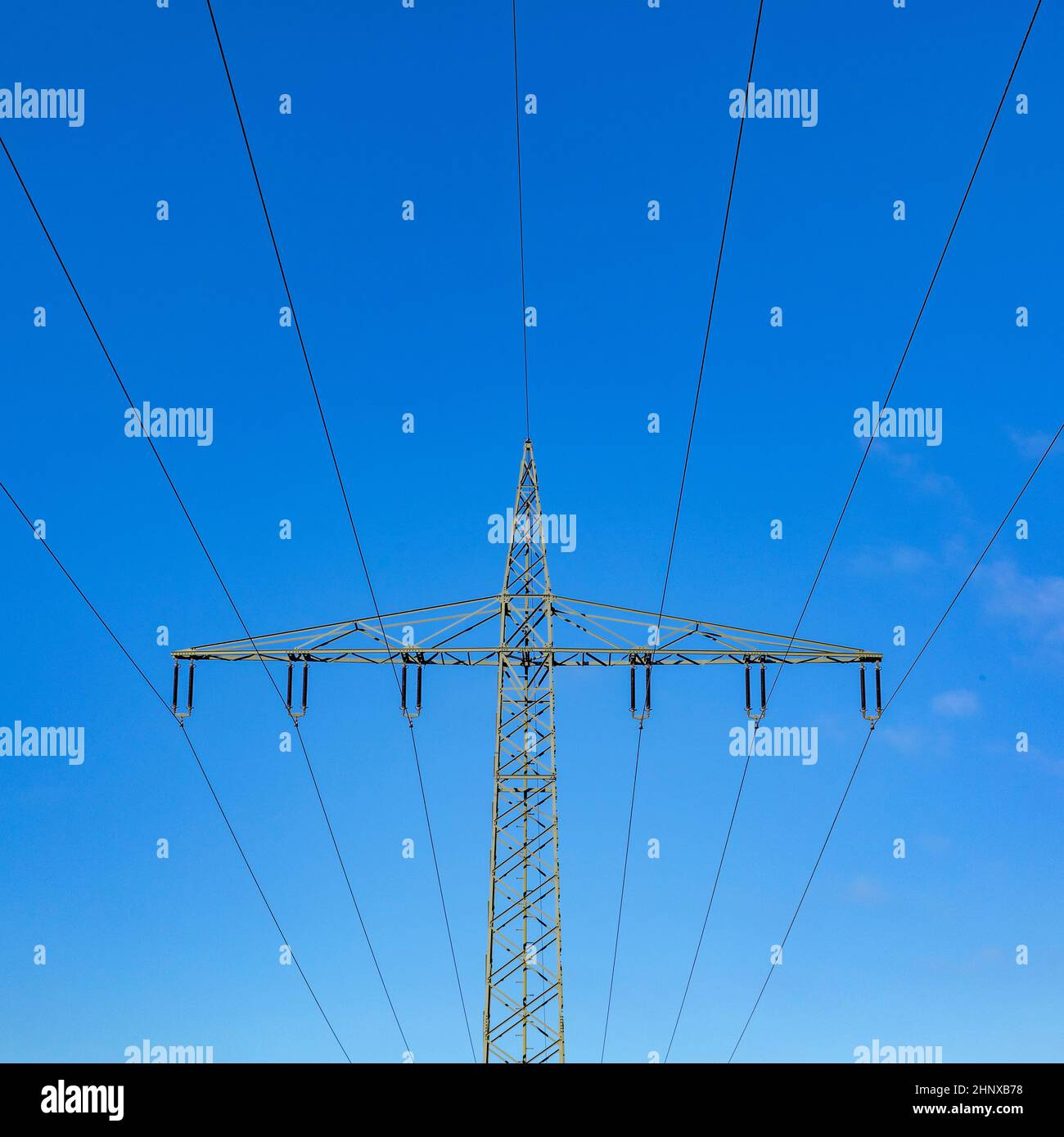 electric pylon under clear blue sky Stock Photo - Alamy