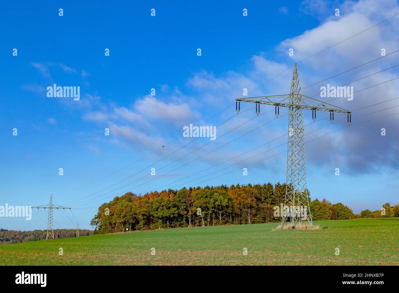 electric pylon under clear blue sky Stock Photo - Alamy