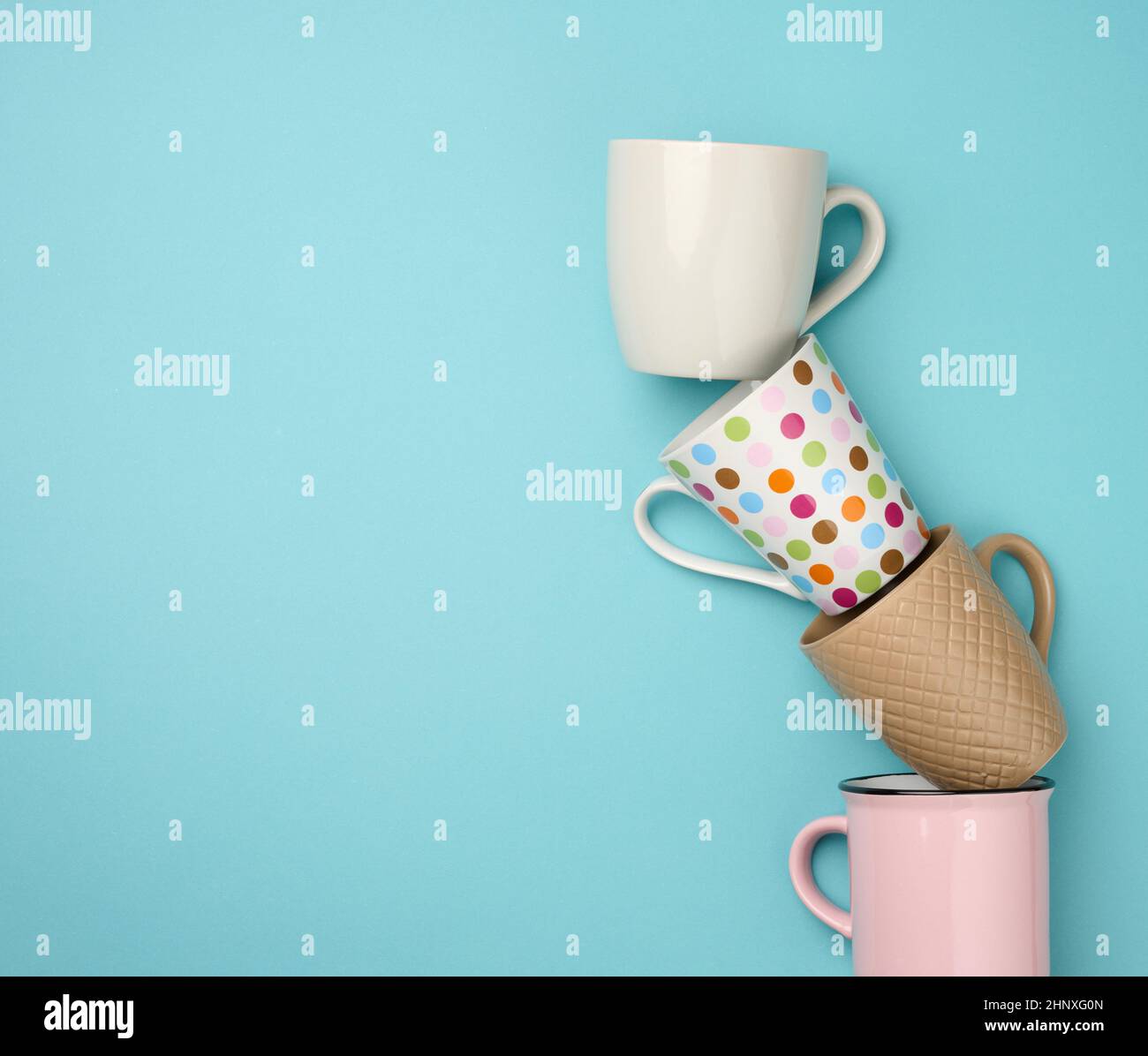 stack of empty ceramic cup on a blue background, flat lay Stock Photo