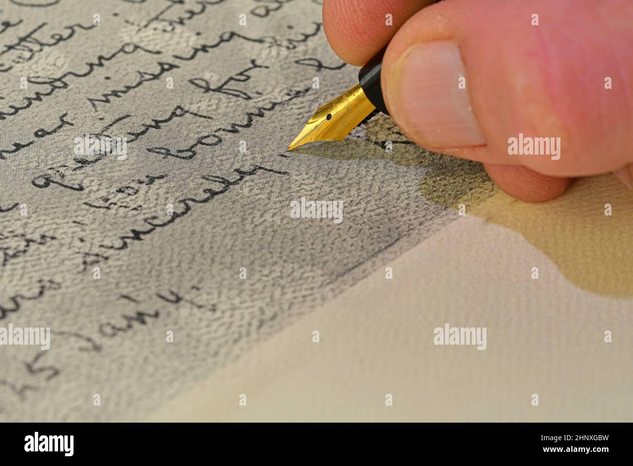 Close-up of a male hand ready to write with an elegant fountain pen ...