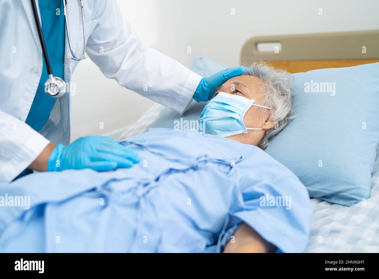 Doctor help Asian senior or elderly old lady woman patient wearing a