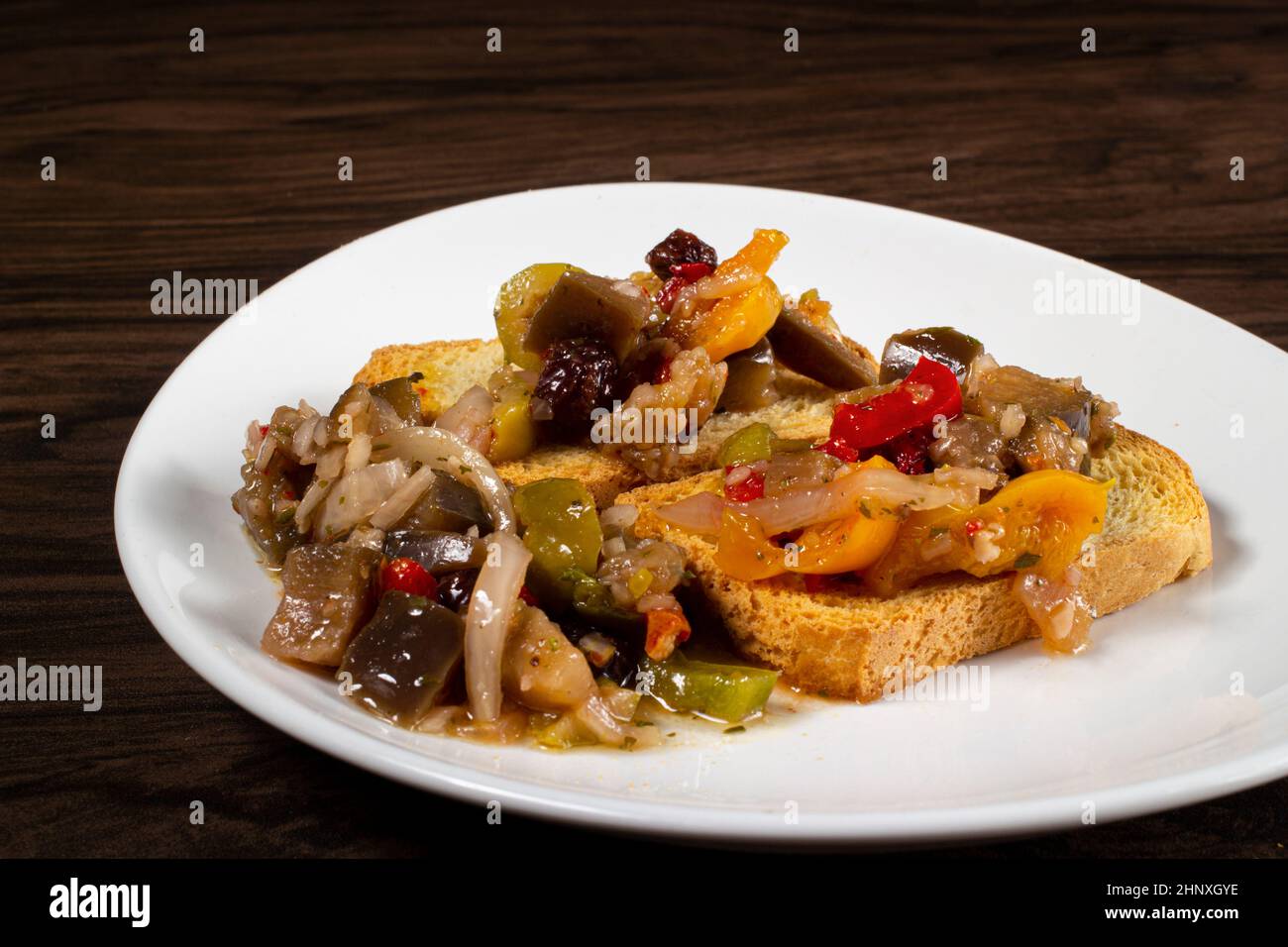 Eggplant appetizer antipasti made with yellow pepper, onion, raisin