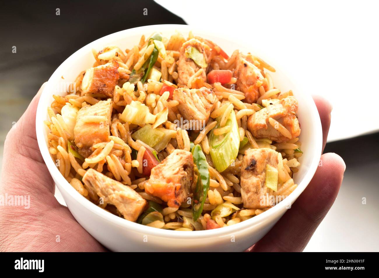 chicken fried rice bowl in hand Stock Photo - Alamy