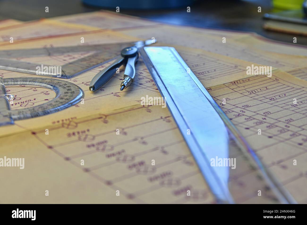 Electrical engineer workplace - electrotechnical project, rulers, and divider compass. Construction and electrotechnology concept. Engineering tools. Stock Photo