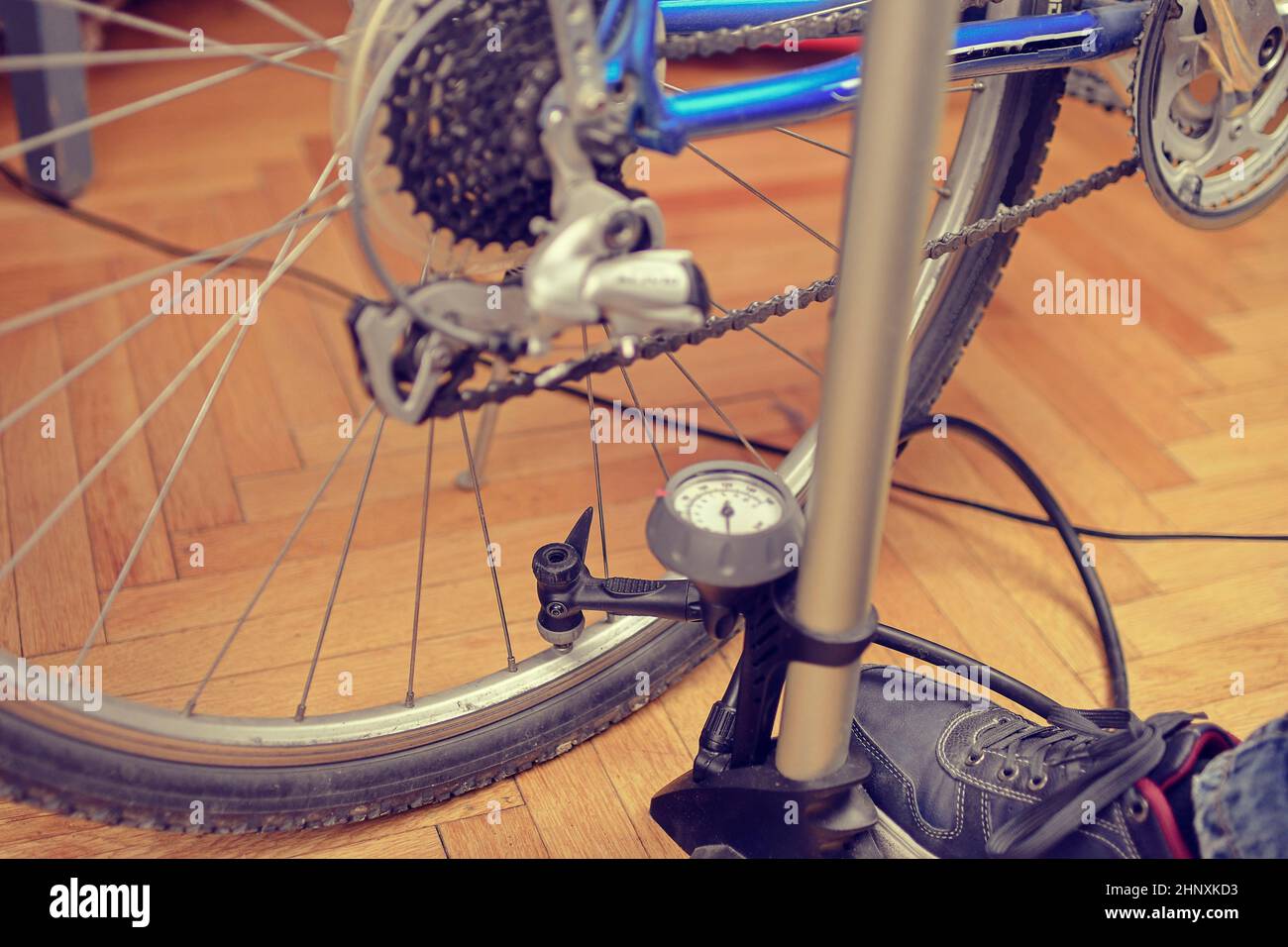Inflating the tire of a bicycle. Pumping air into a wheel of bike. Home