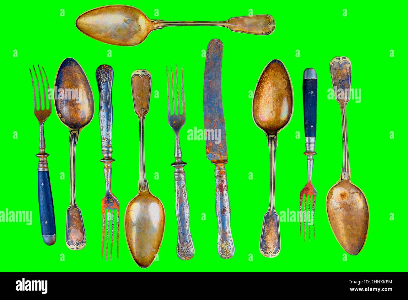 Vintage cutlery on a green background. Top view. Crazy concept for