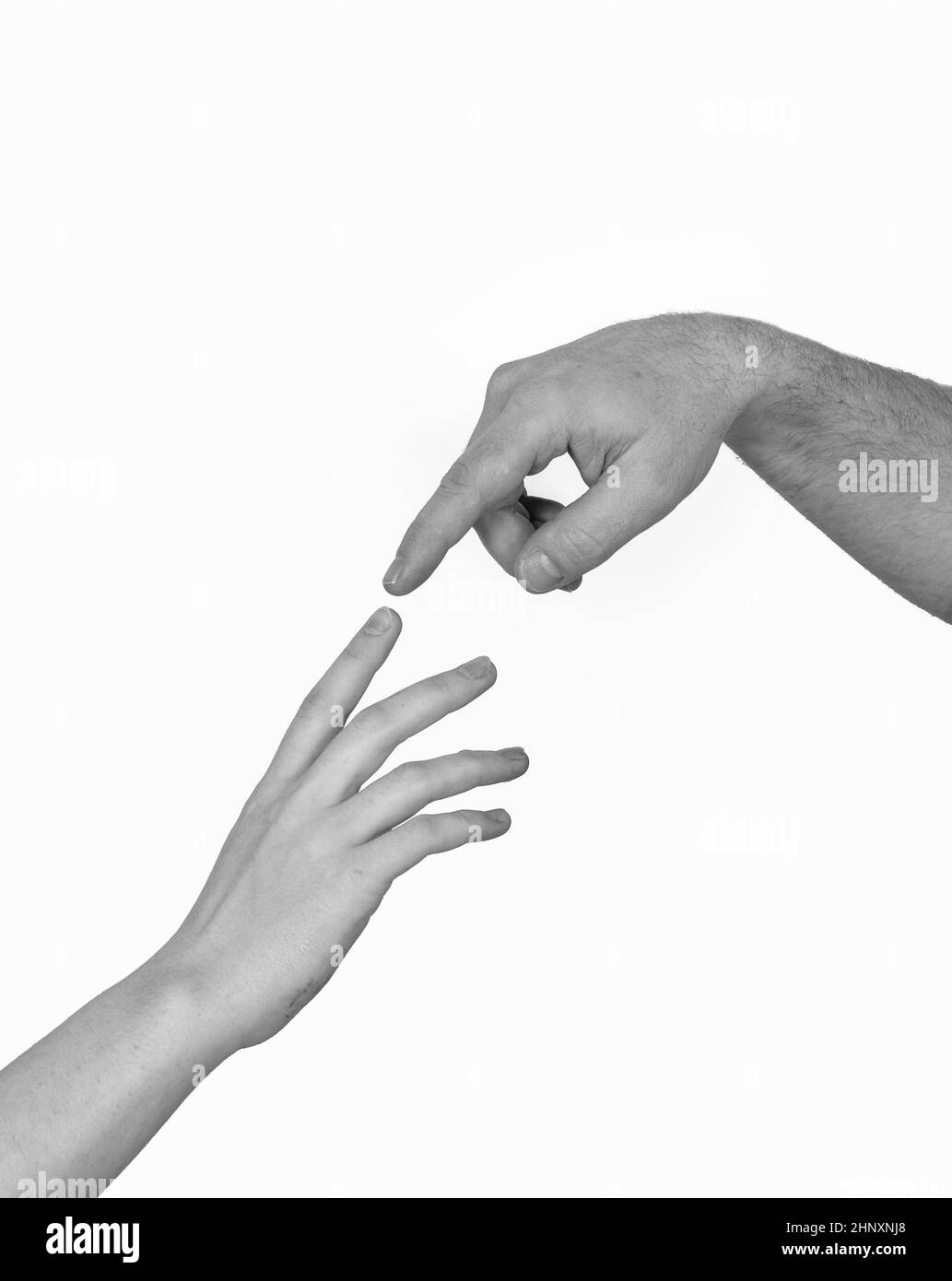 Male and female hands touching each other by index finger Stock Photo