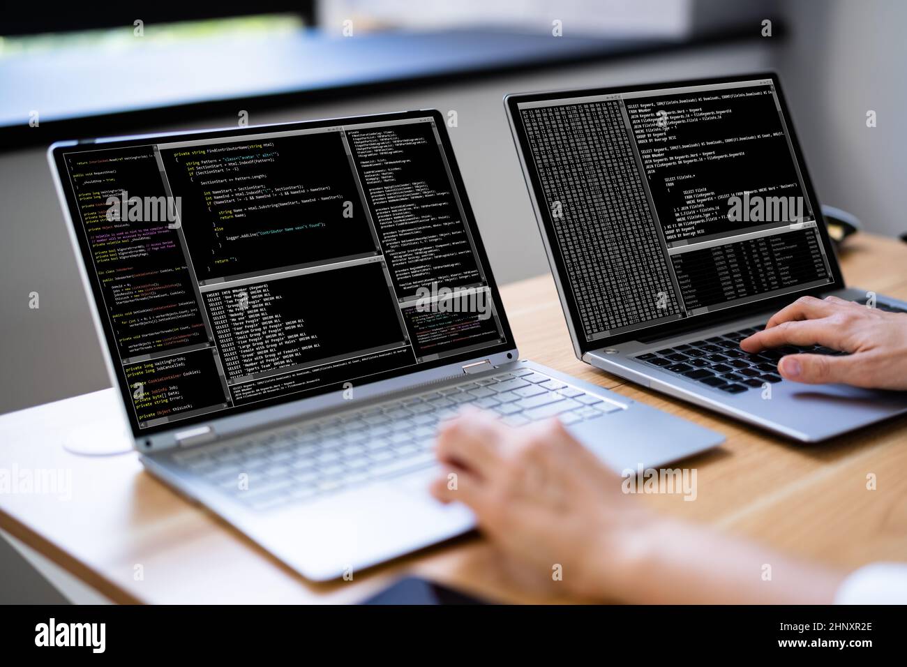 Programmer Woman Coding On Multiple Computer Screens Stock Photo - Alamy