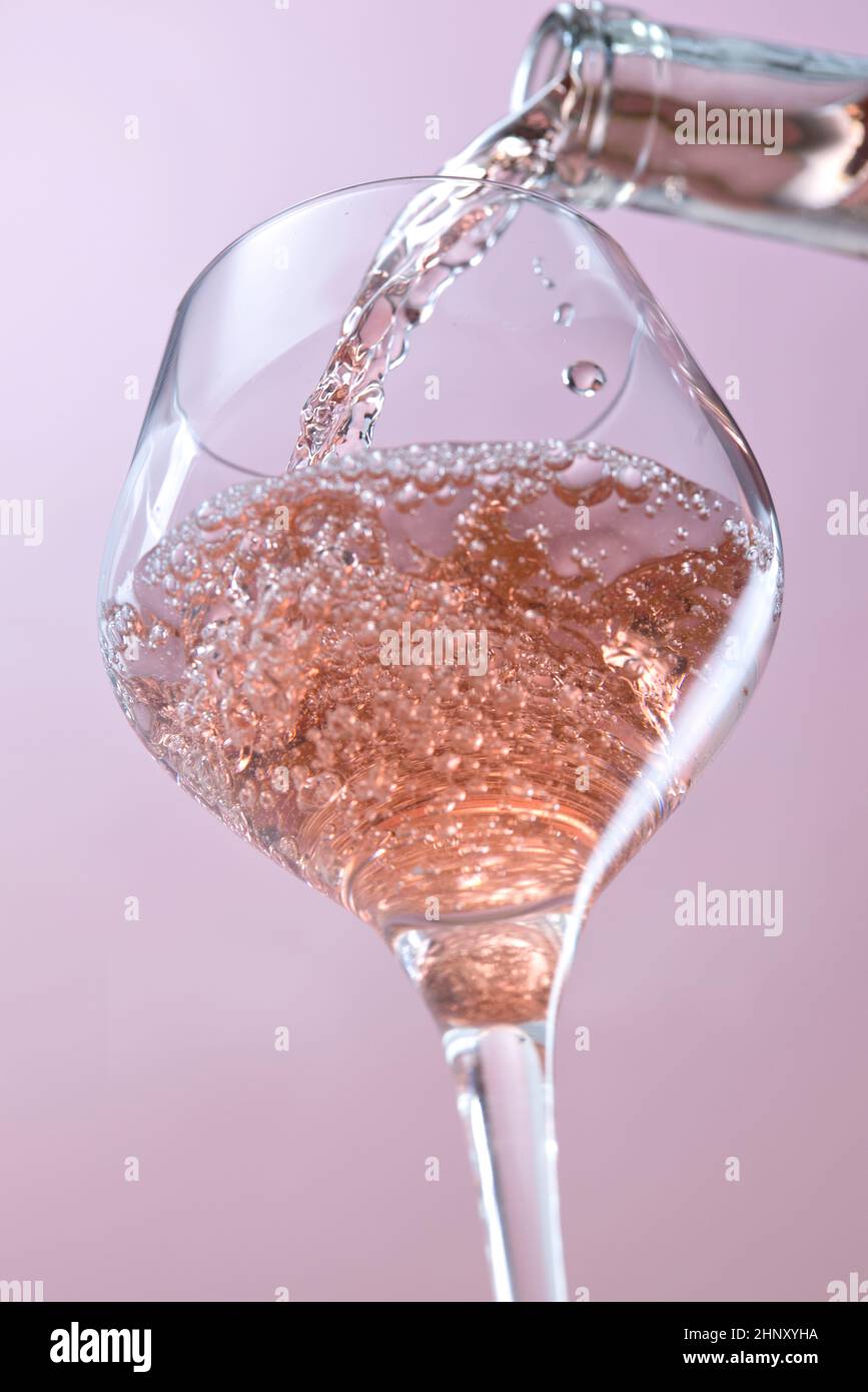 A concept studio image of pouring rose wine into a wine glass Stock ...