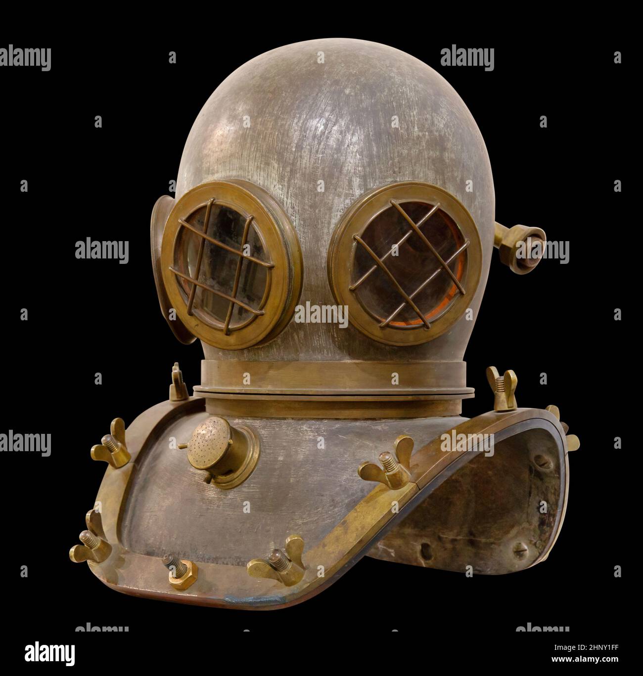 Old antique metal scuba helmet isolated on black background with