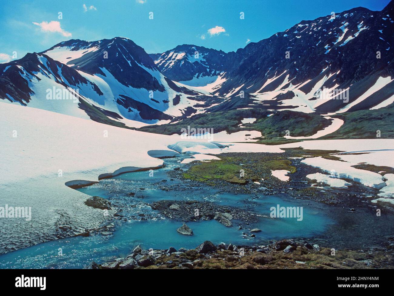 Early Summer Snow in a High Mountain Pass at Crow Pass in Alaska Stock