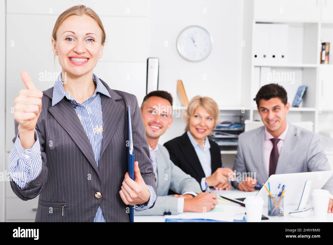 Business woman showing thumbs up Stock Photo - Alamy