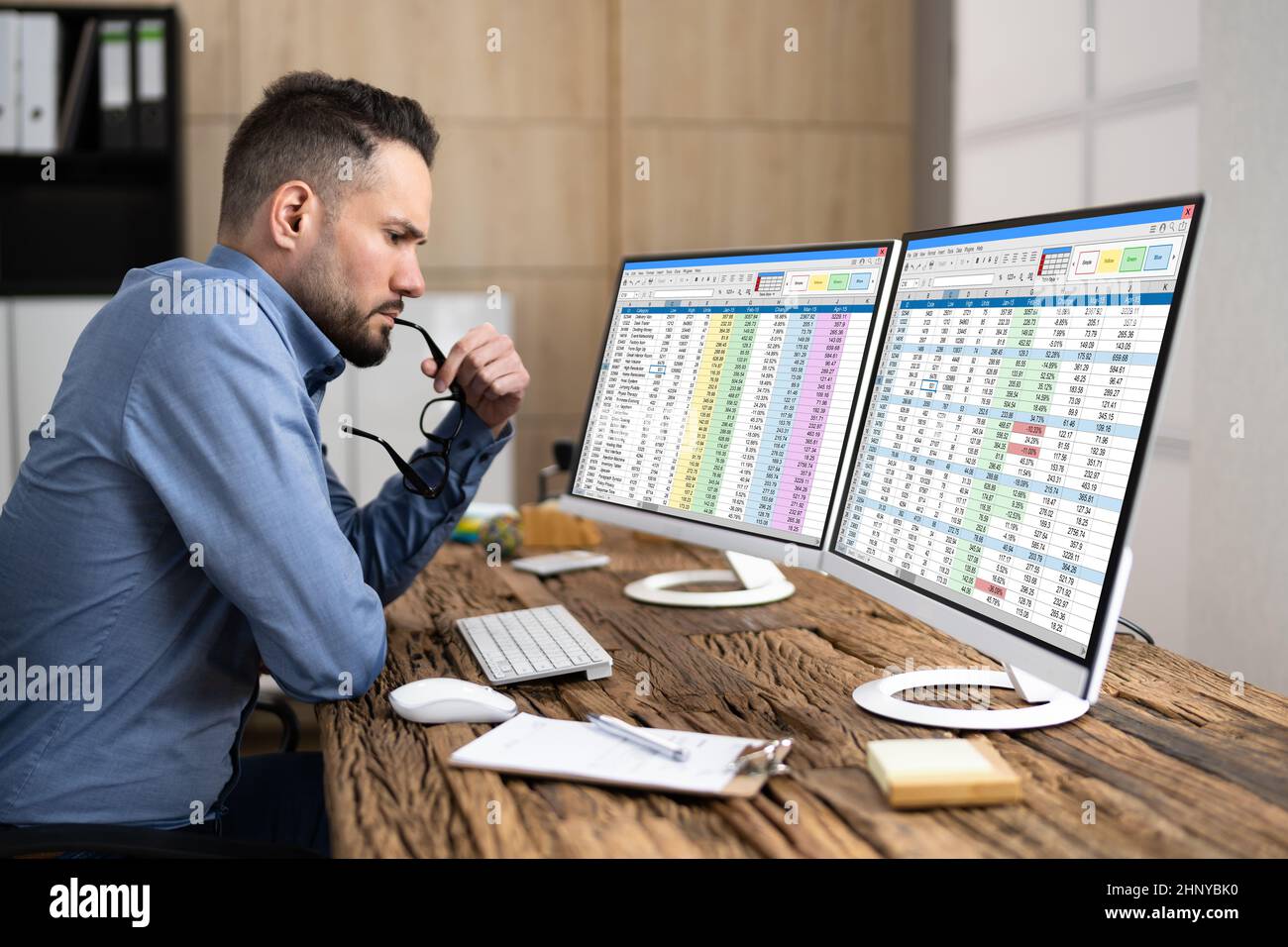 Computer Spreadsheet Data Analyst Man Using Multiple Screens Stock Photo