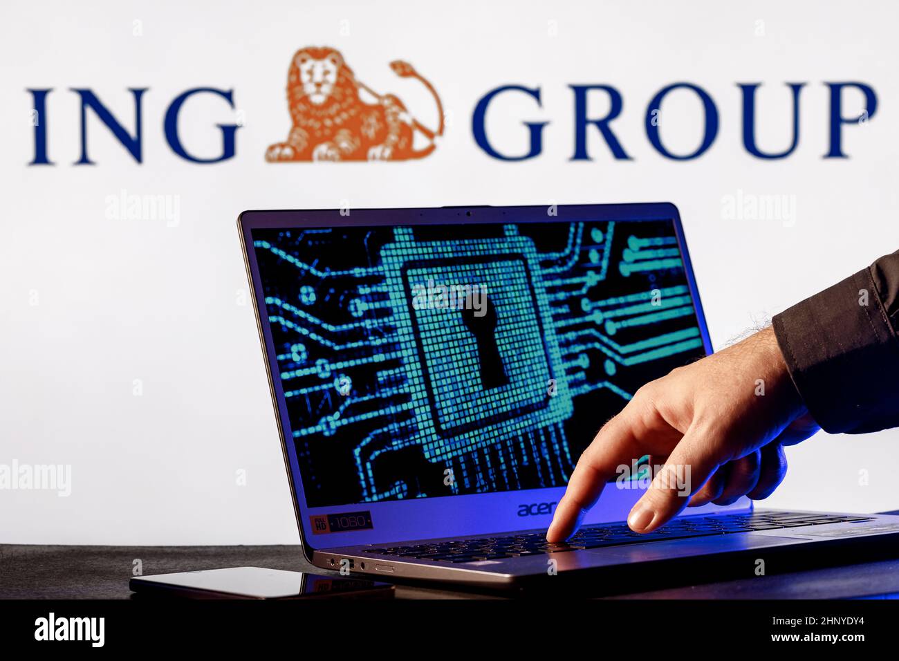 Laptop with lock symbol on screen on background of  ING Group logo. Finger points to lock symbol. Concept of data hacking. Stock Photo