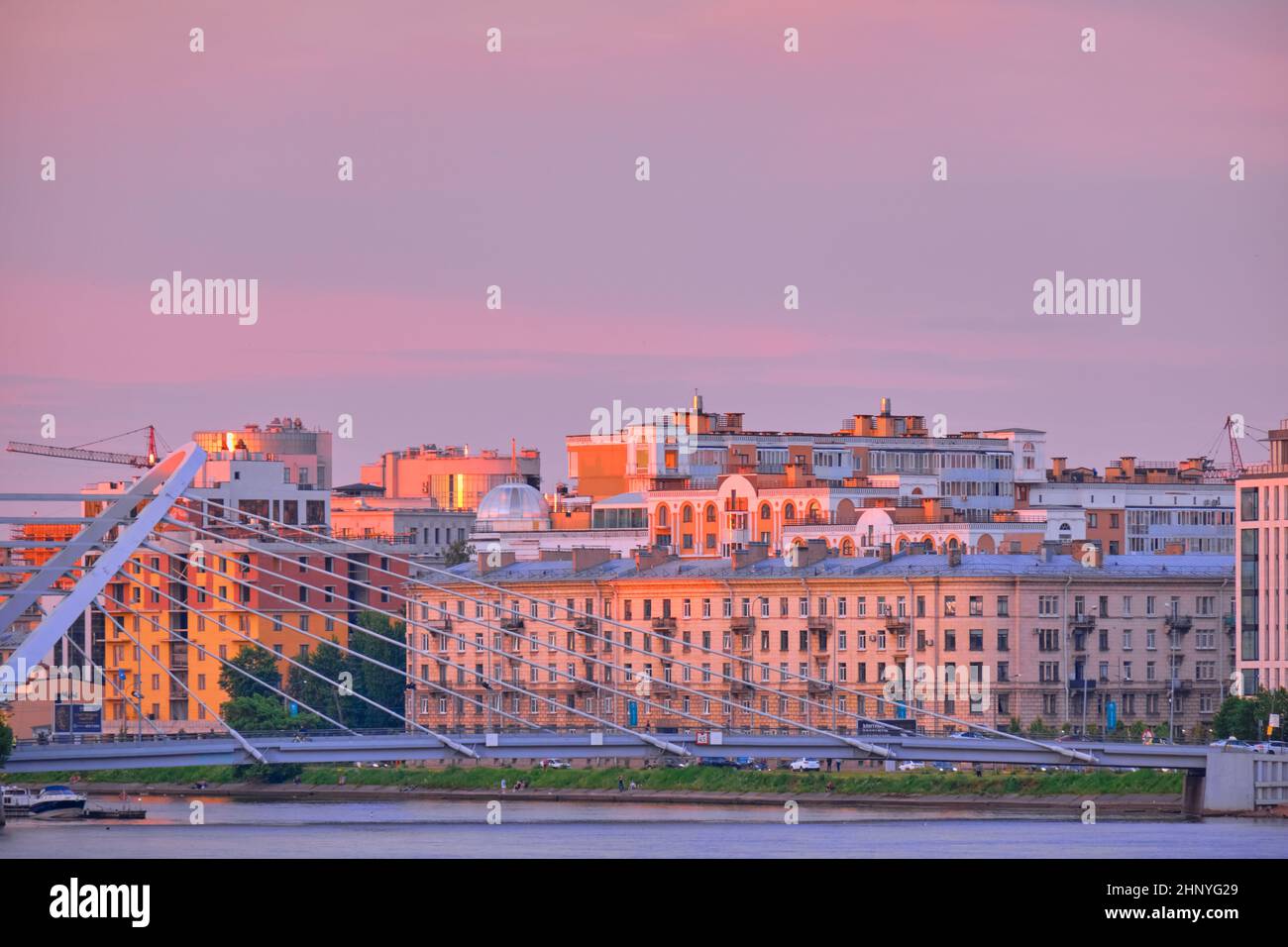 Saint-Petersburg, Russia - Jun 09, 2021: New houses in the Nevsky Bay area at sunset. Boats and boats move on the water Stock Photo