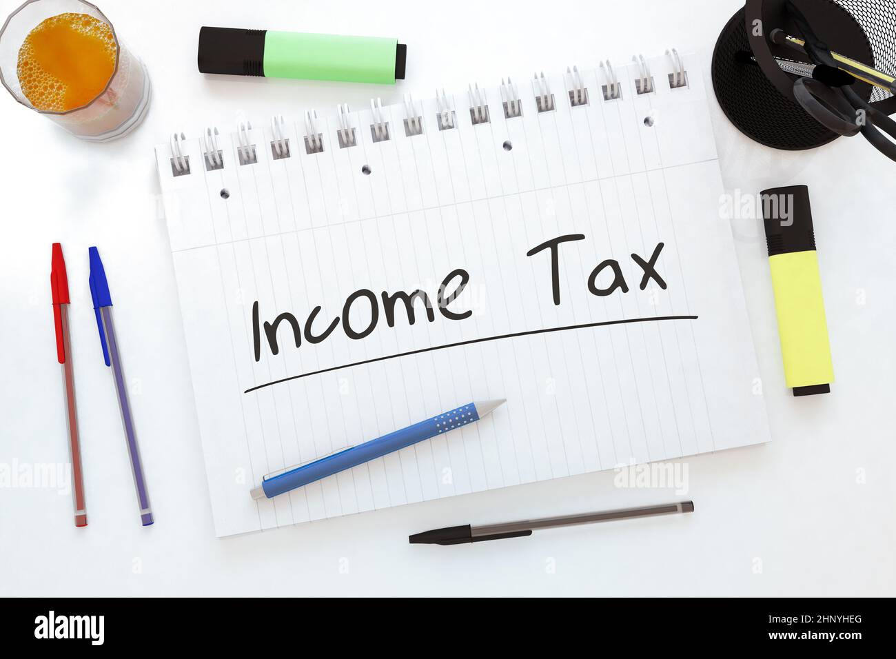 Income Tax - handwritten text in a notebook on a desk - 3d render illustration. Stock Photo
