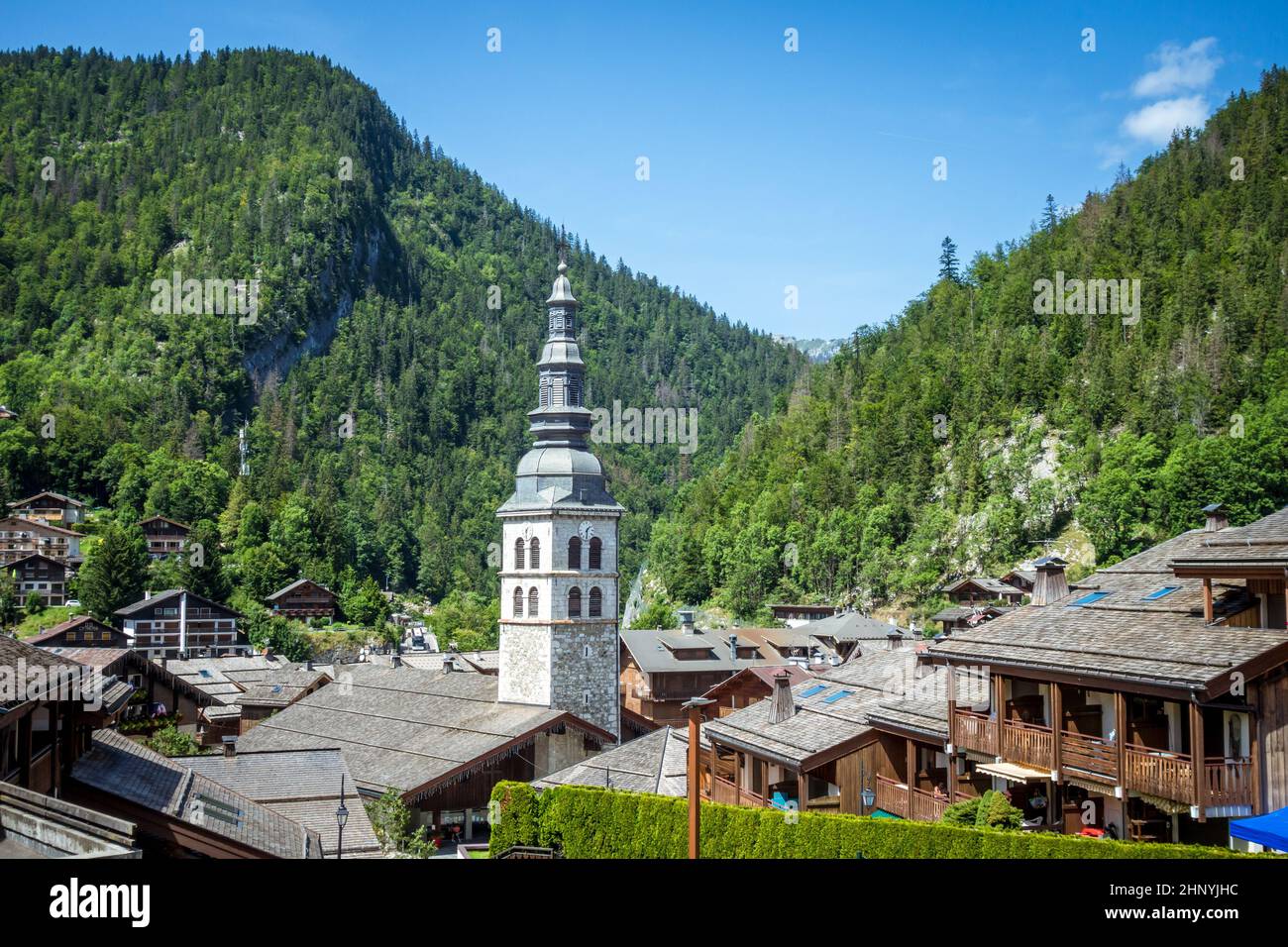 Church and the village of La Clusaz in summer, France Stock Photo