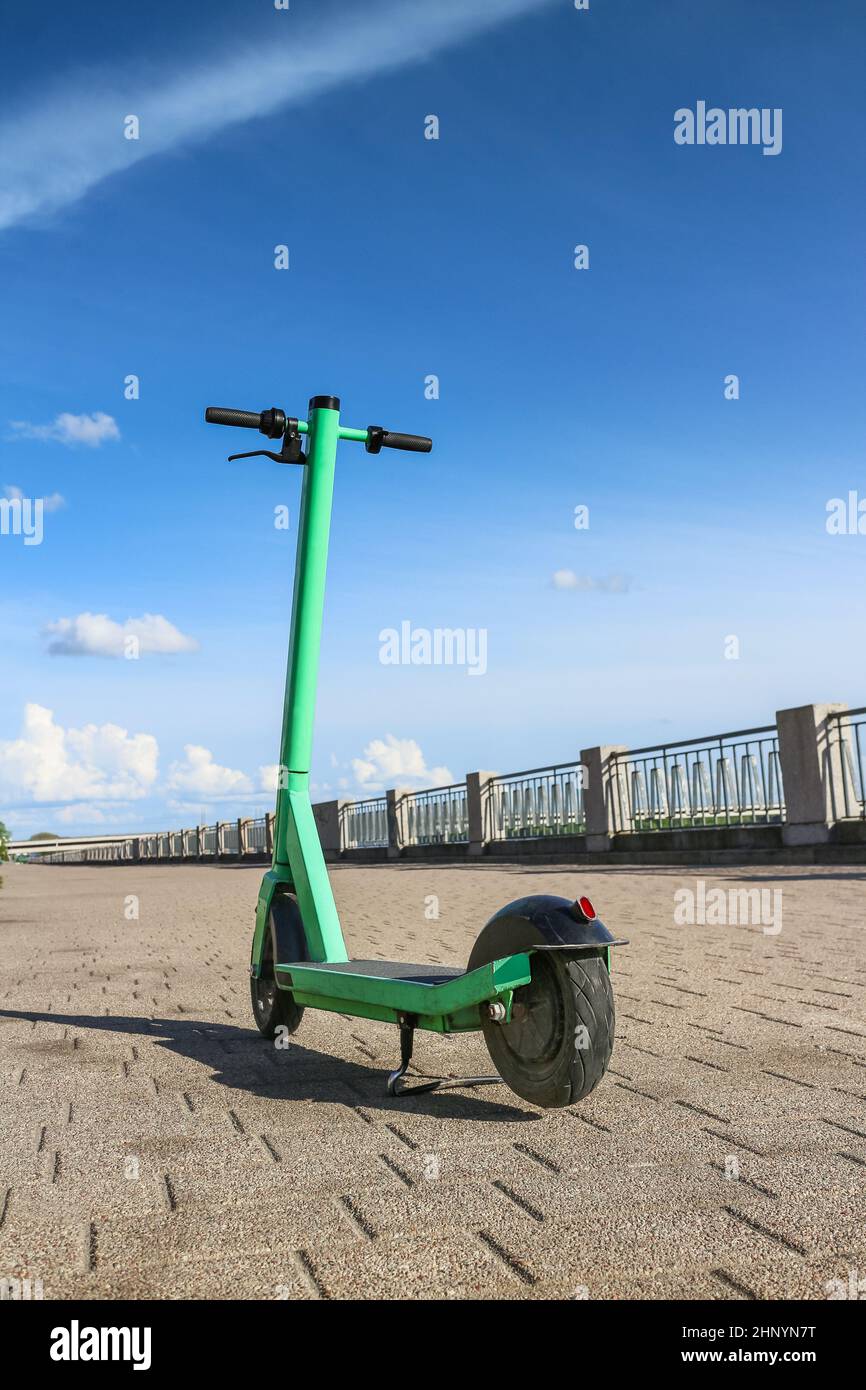 Electric scooter parked for rent and online booking in the application. Electric scooter eco-friendly transport in the city for sharing service. Stock Photo
