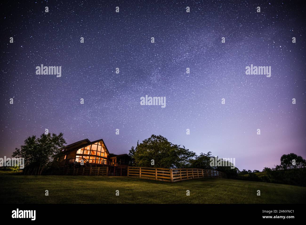 View of night sky and the Milky Way with a house in rural Kentucky in