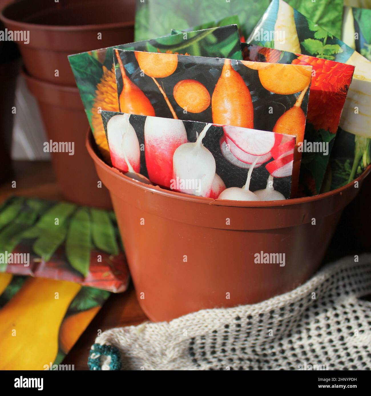 Seeds in packets in pot Stock Photo