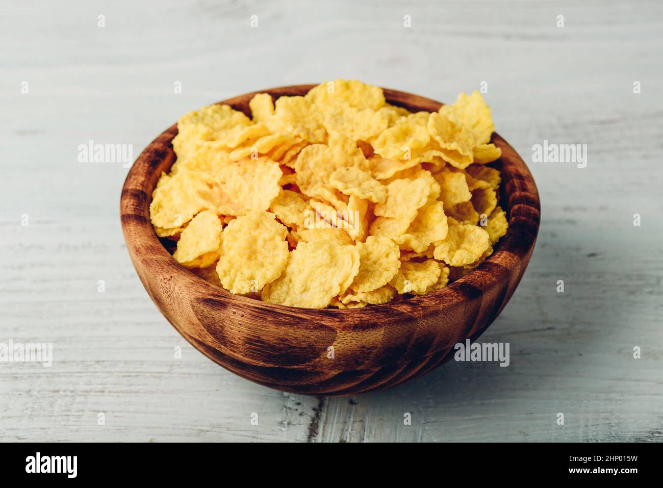 Corn flakes in a wooden rustic bowl Stock Photo Alamy