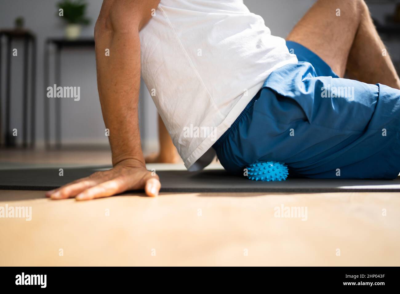 Glutes Trigger Point Massage Using Spiky Ball Myofascial Release Stock