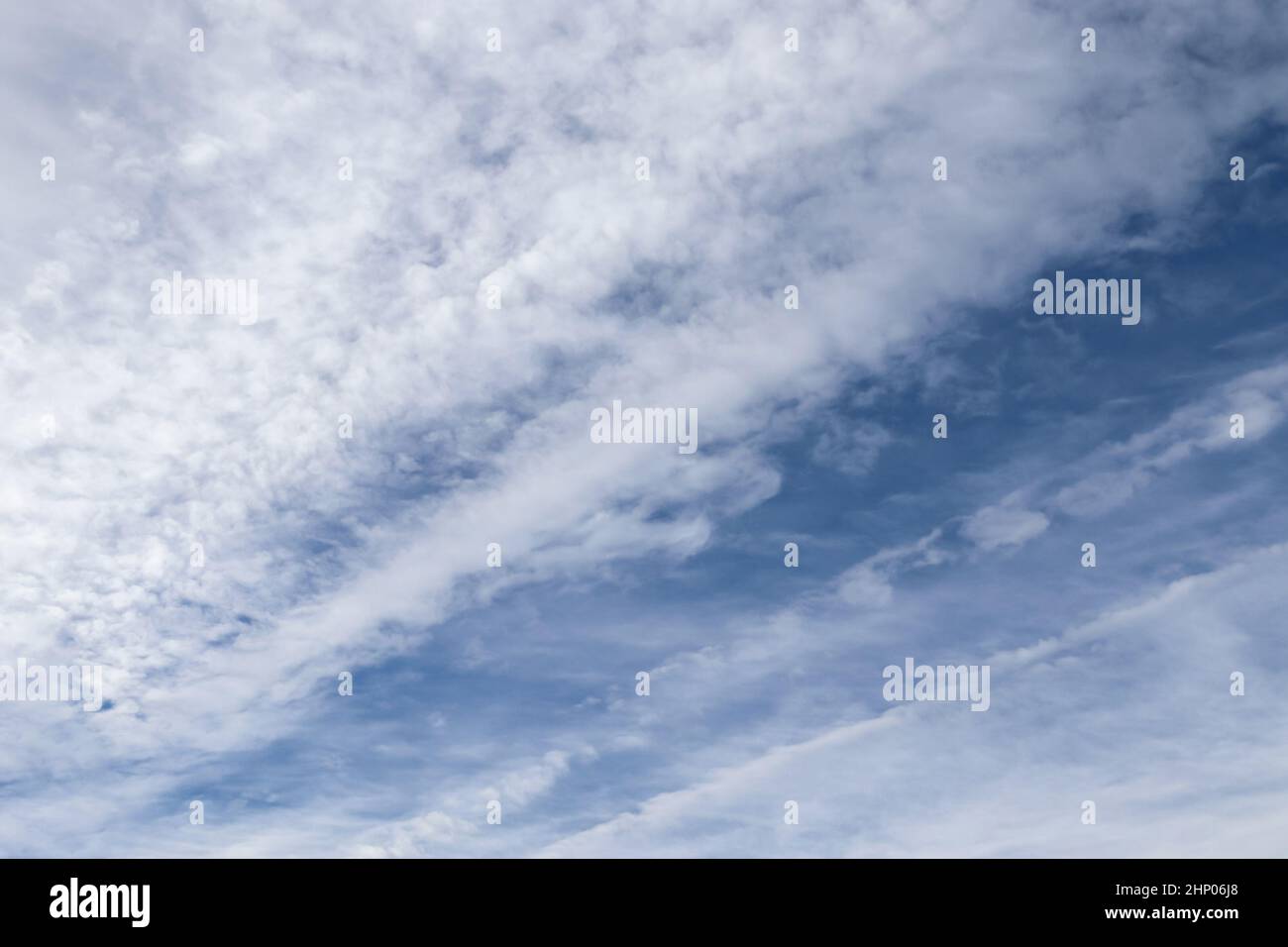 Stunning mixed cloud formation panorama in a deep blue summer sky. Stock Photo