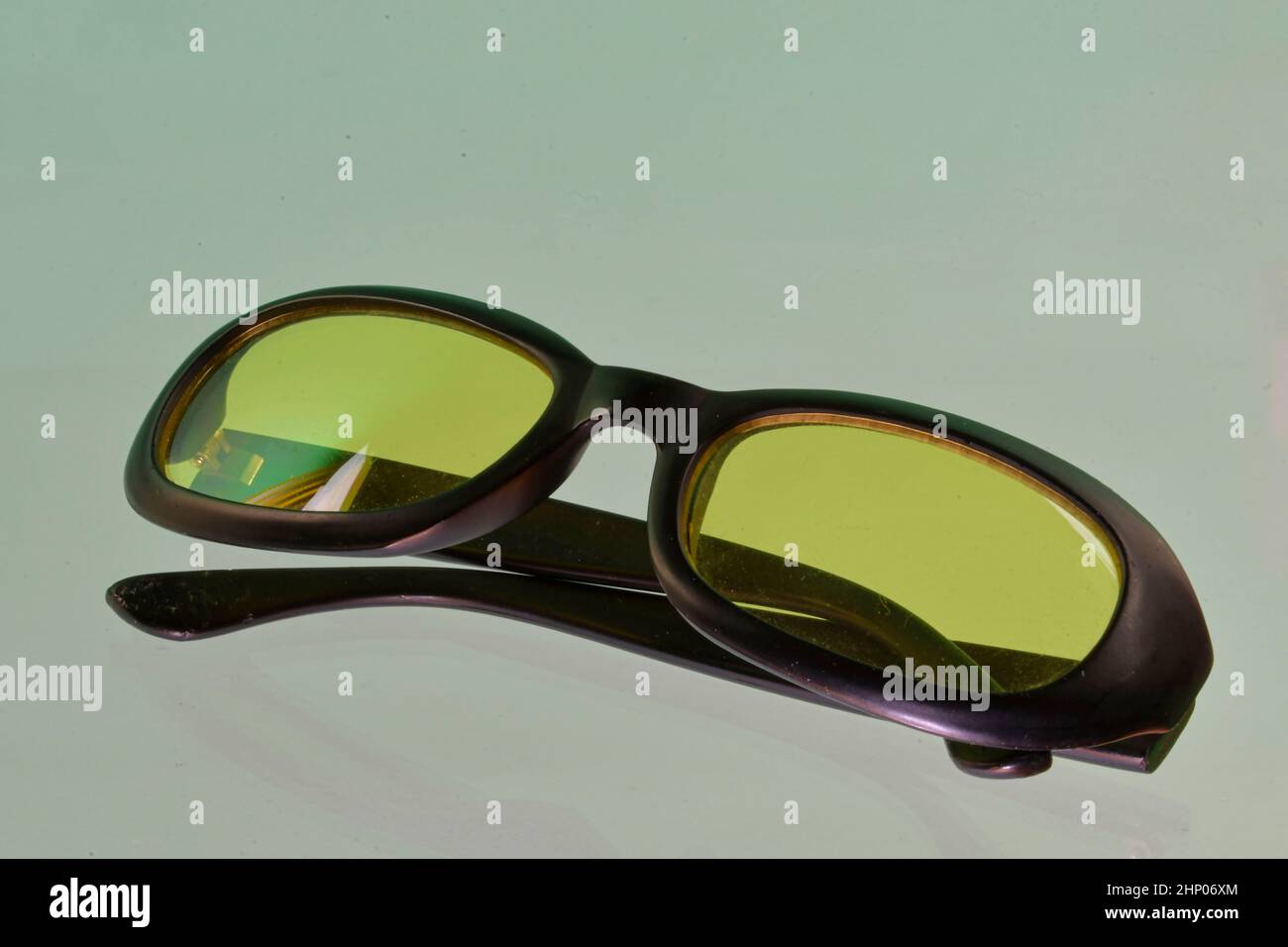 Reflection of sunglasses. Green sunglasses, close-up. Sun glasses. Old style sunglasses. Glasses with transparent lenses. Vintage sun glasses on refle Stock Photo
