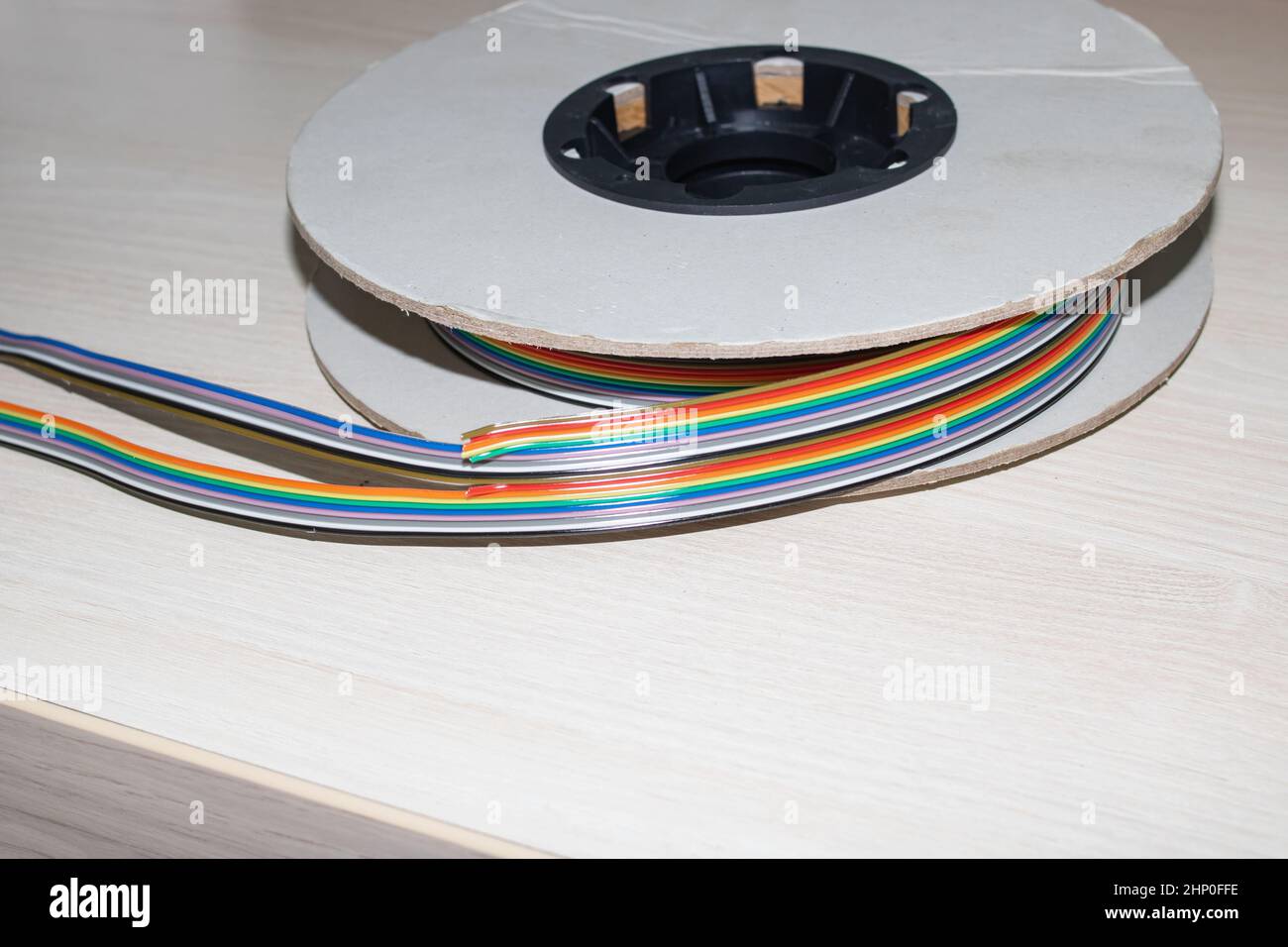 Coil of multicolored wires in hand close up Stock Photo Alamy