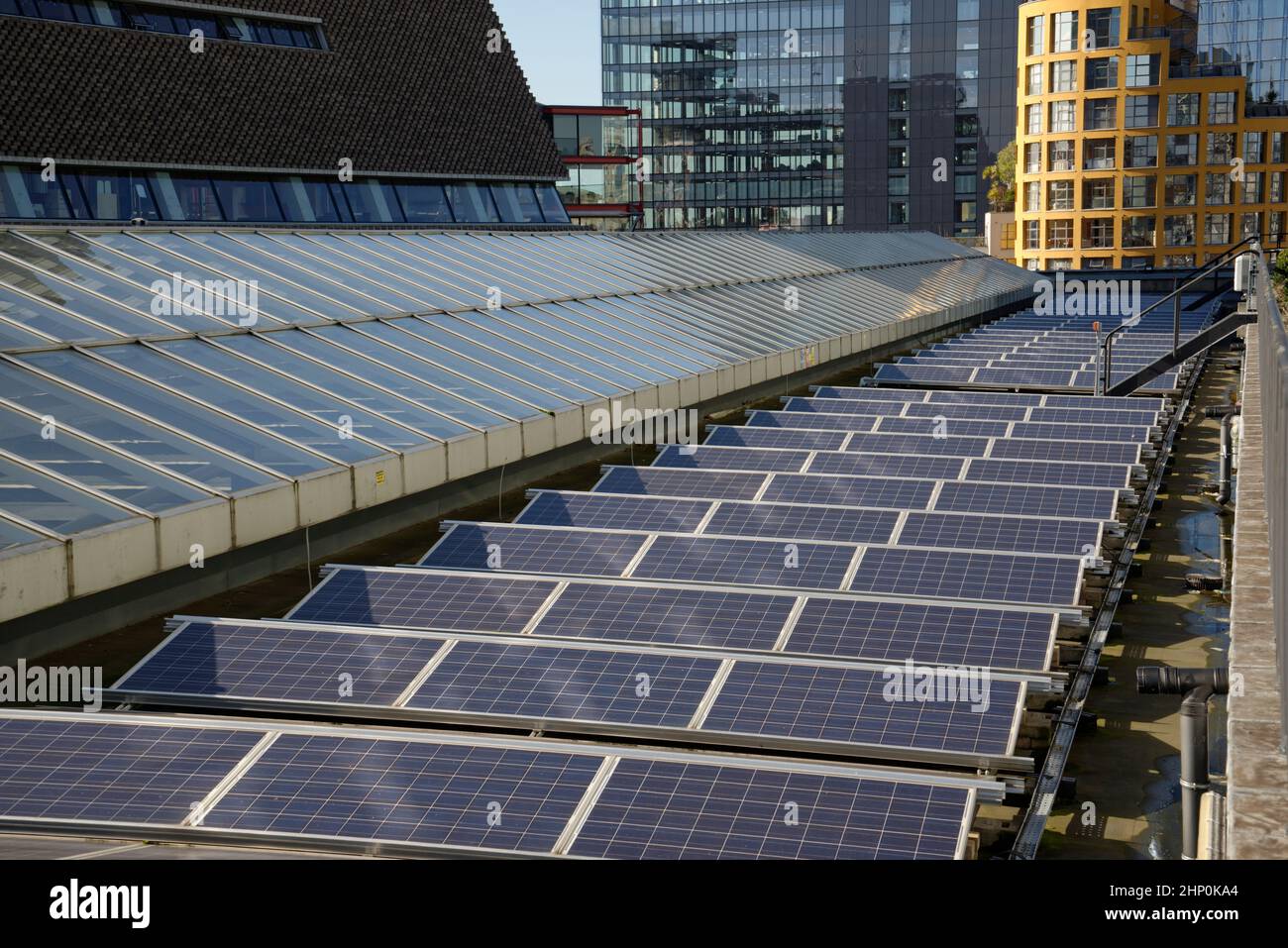 Solar panels on top of buildings in central London, UK. Electricity generation in the city atop of municipal property. Tate Modern art gallery, London. Stock Photo