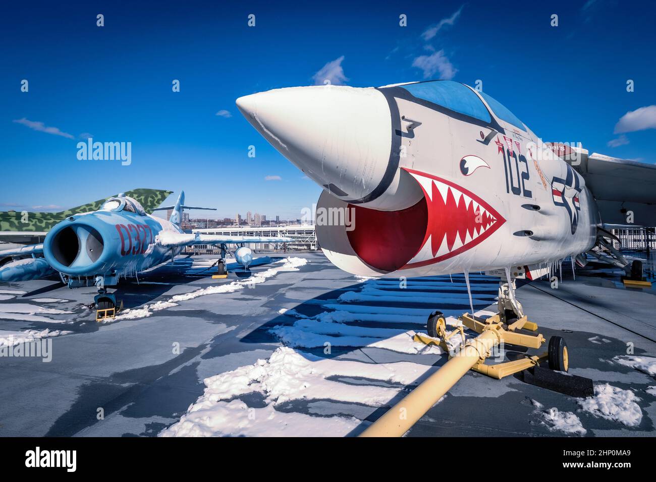During the cold war defected MiG 17 side-by-side an American F-8 Corsair on the flight deck of USS Intrepid Sea, Air and Space Museum in NYC, NY, USA Stock Photo