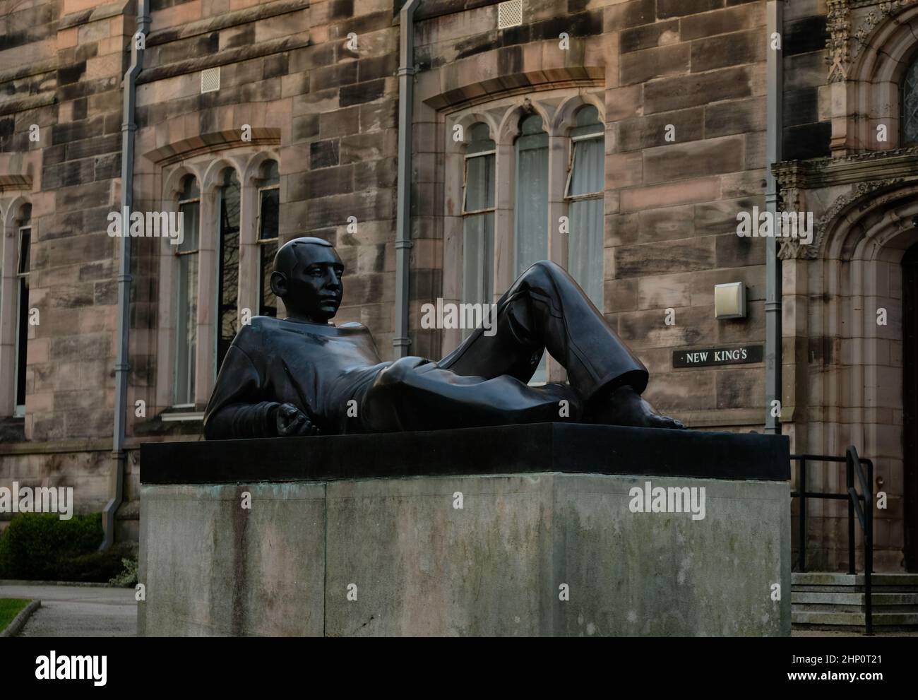 A photograph of a statue located to the fore of 'New King's, Aberdeen University.  The statue is entitled 'youth with a split apple'. Stock Photo