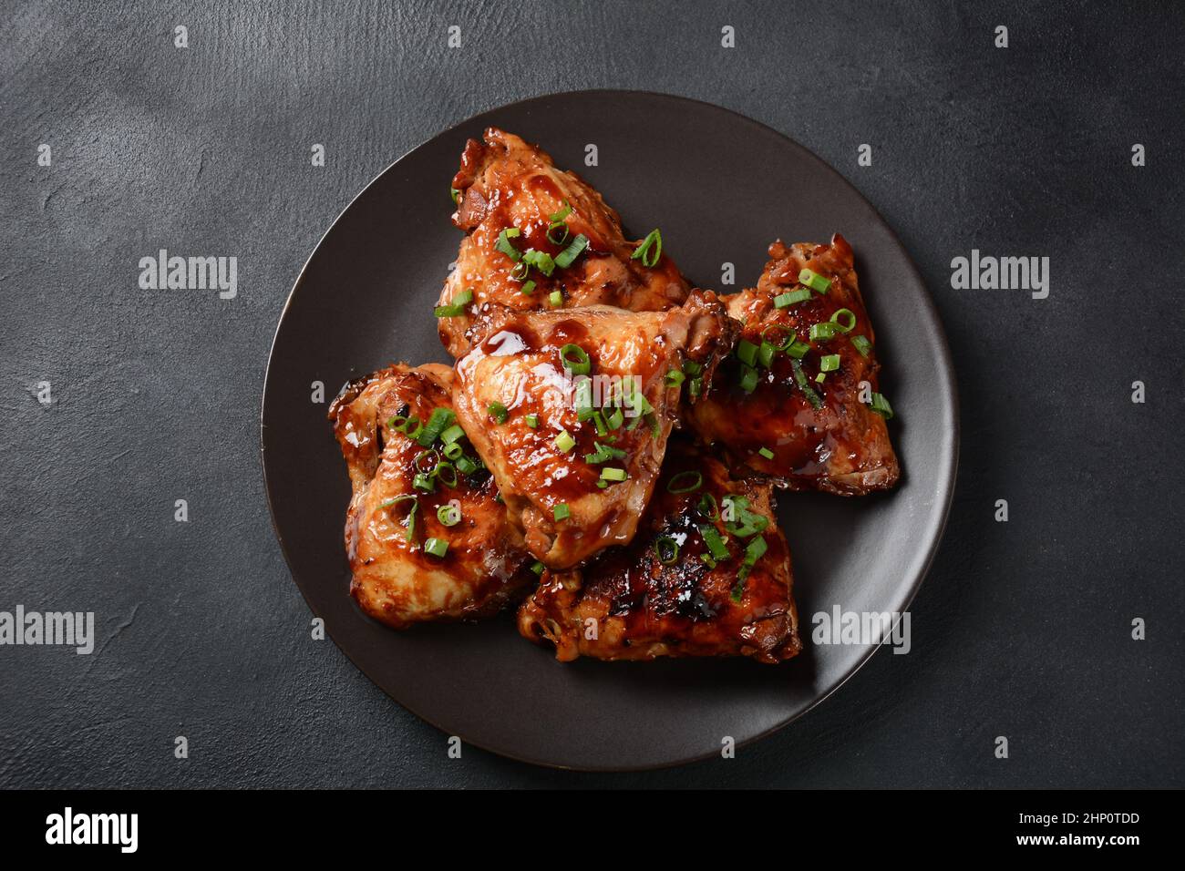 Homemade Filipino Adobo Pork in a white bowl on a black ...
