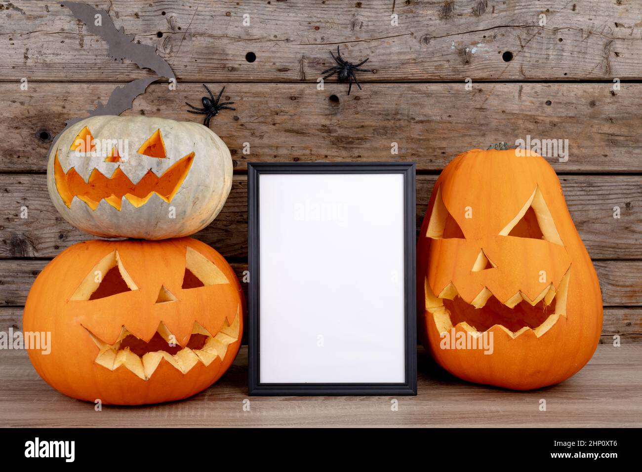 Composition of halloween decoration with jack o lanterns and frame with ...