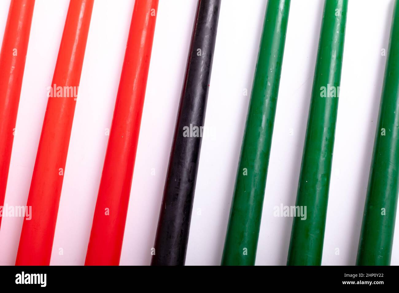 Composition of halloween candles in red black and green on white background Stock Photo