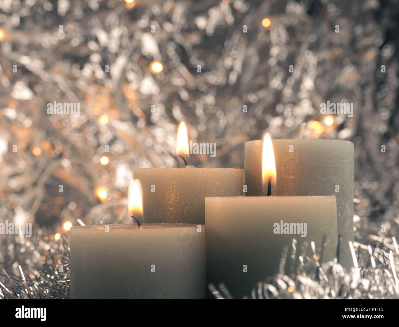 Third advent candle burns silver background with text free space stock