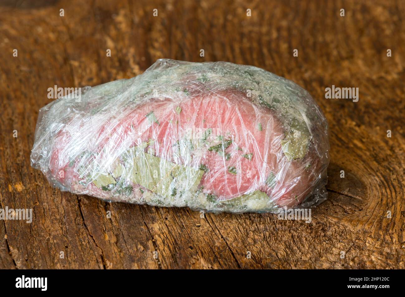 wrapped raw beef fillet on wood Stock Photo