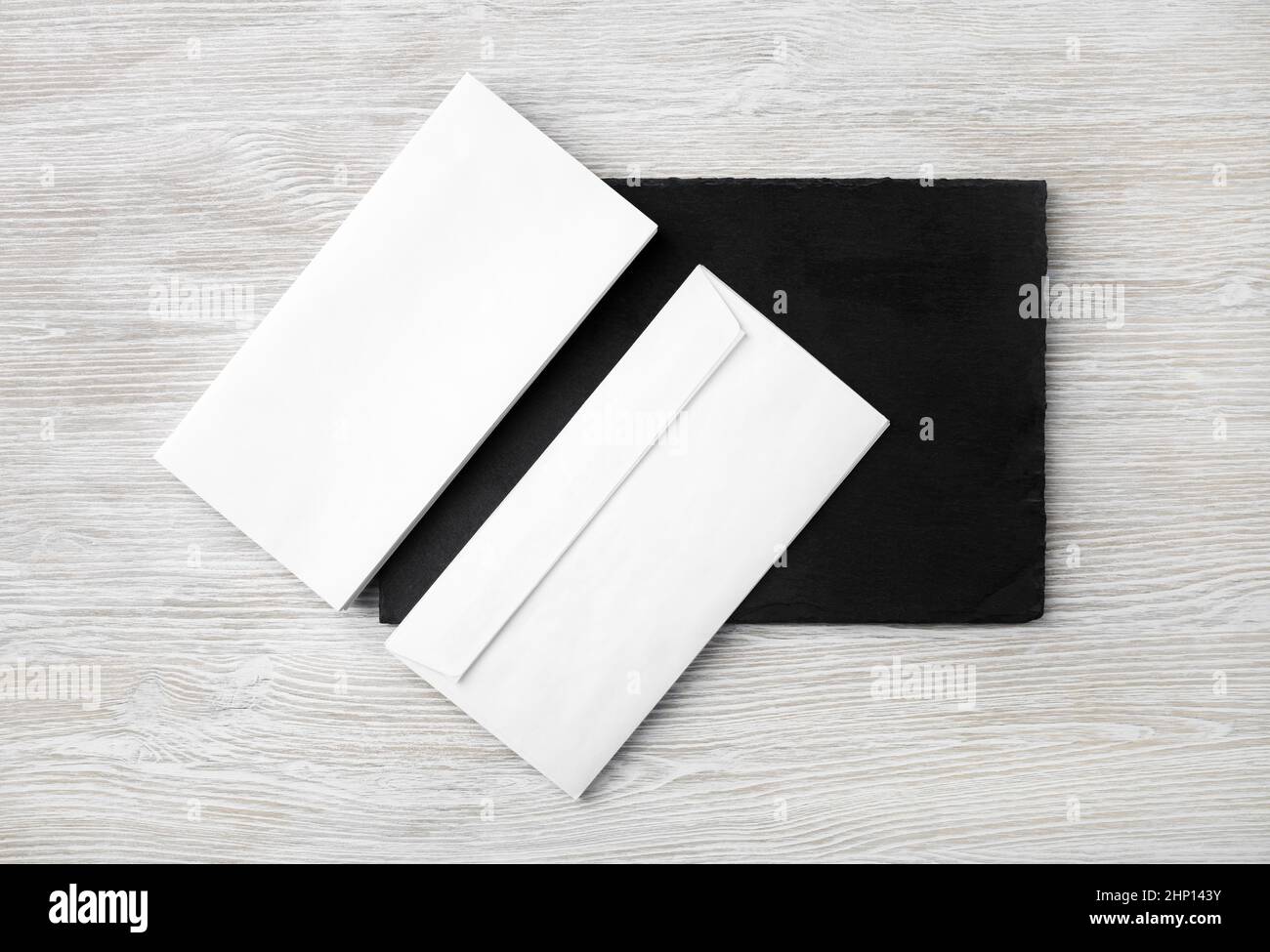 Blank white envelopes on stone board. Copy space. Flat lay. Stock Photo