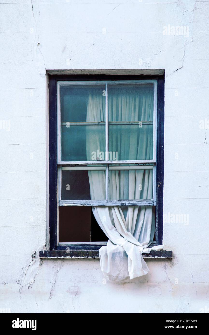 Open Window With Curtain hanging Out Stock Photo