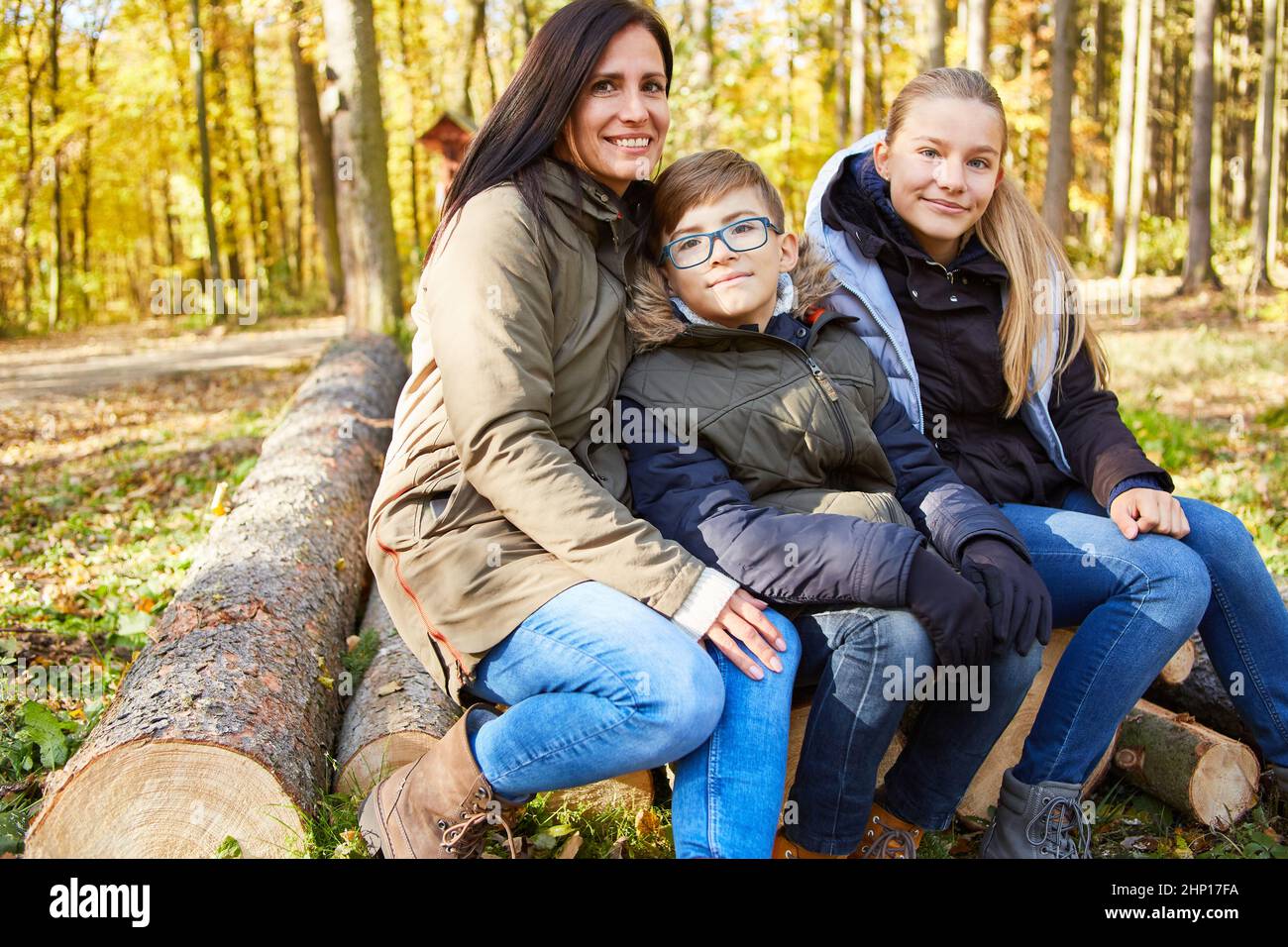 Teacher and two children in the forest during forest pedagogy lessons for nature conservation and ecology Stock Photo