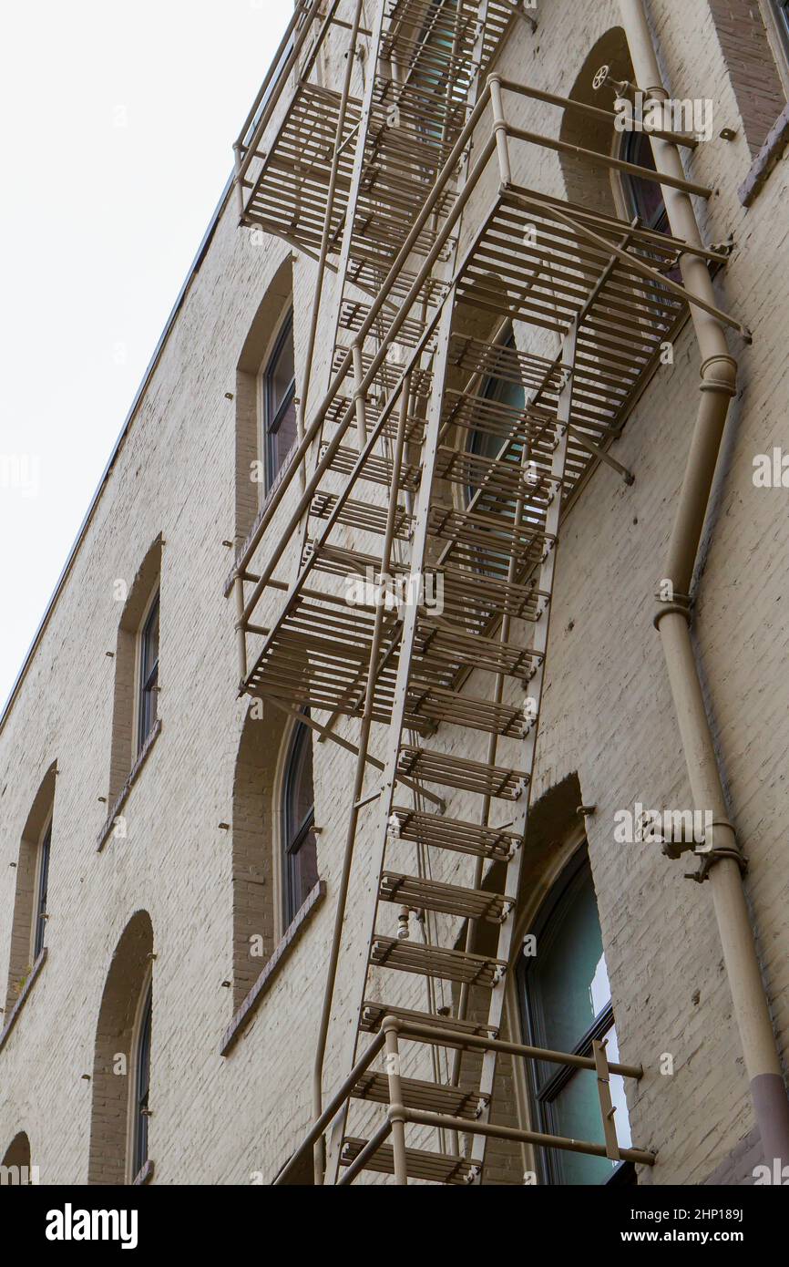A fire escape is on the side of an old building in downtown SPokane, Washington. Stock Photo