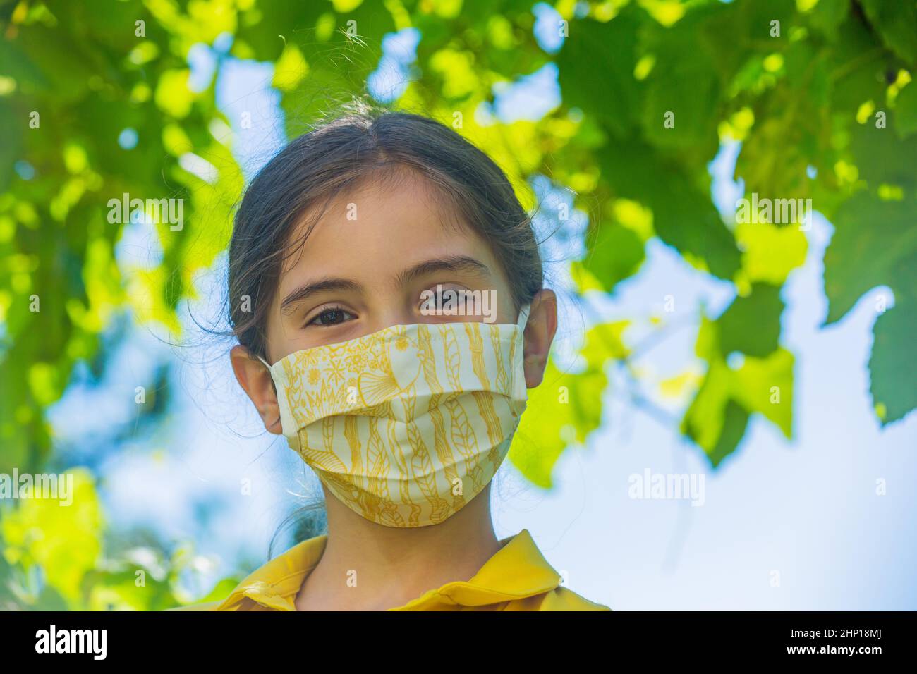 Little girl with mask against corona virus covid outdoor Stock Photo