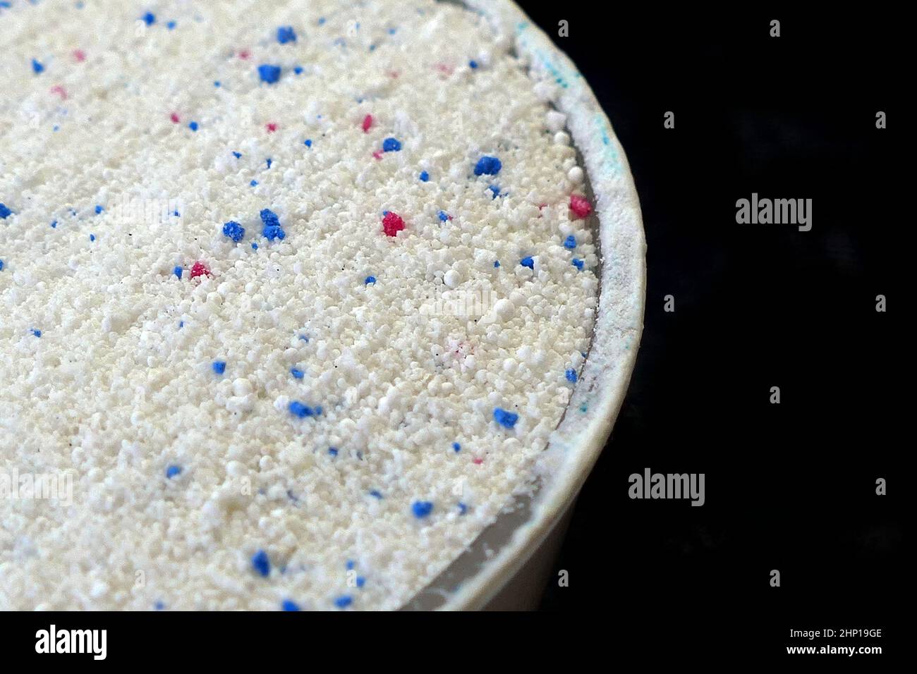 a measure of powdered laundry detergent, closeup laundry detergent