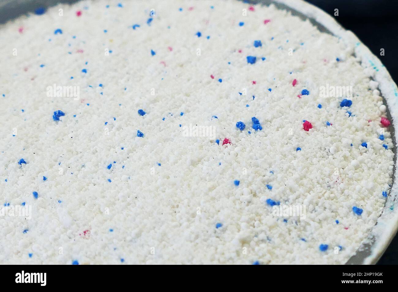 a measure of powdered laundry detergent, closeup laundry detergent