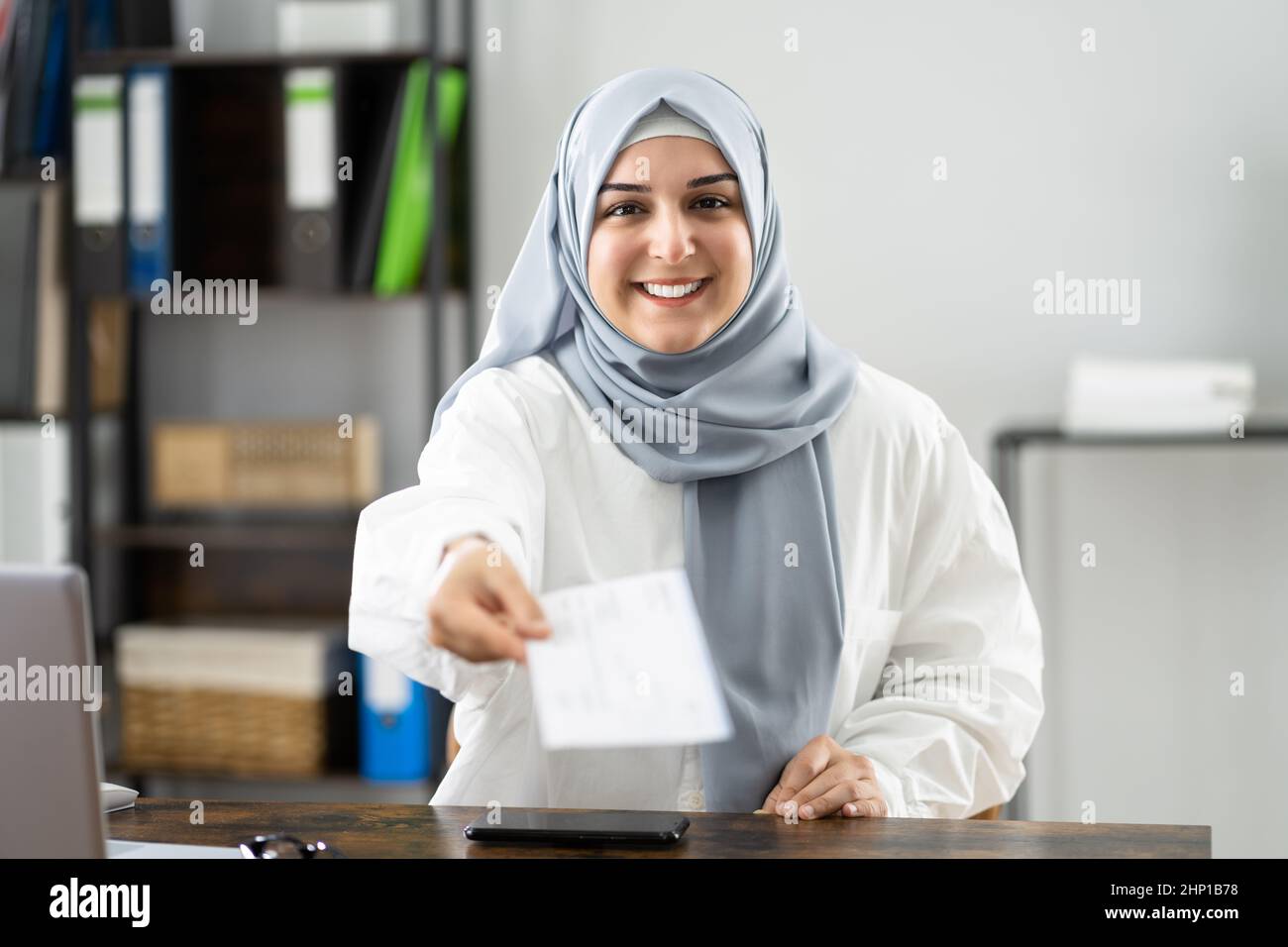 Muslim Woman Giving Payroll Cheque Or Paycheck Stock Photo - Alamy