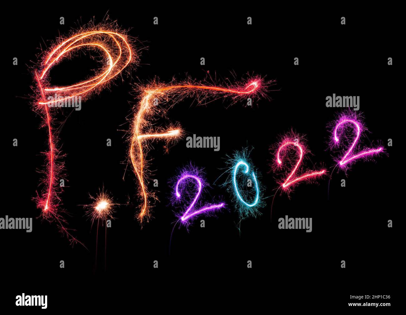 New year greeting card. P.f. pour feliciter 2022 made from sparkling colorful lights isolated on black background. Happy new year. Stock Photo