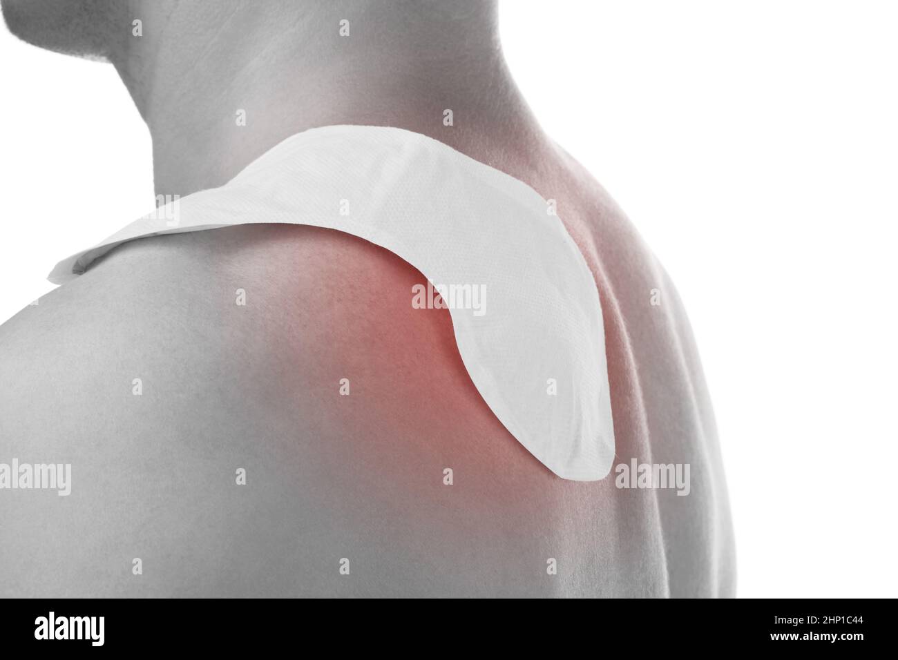Handsome man with heat patch on shoulder. Shoulder and chronic back pain. Stock Photo